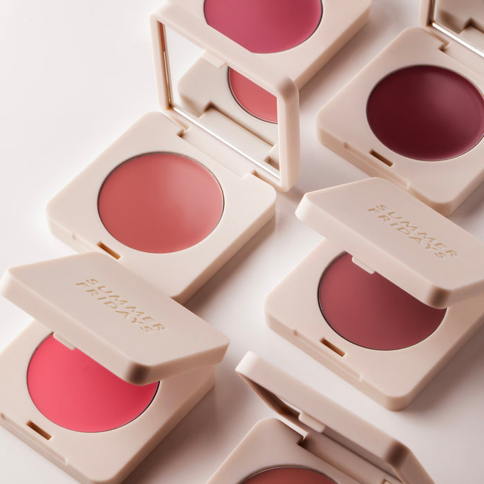 Multiple blush compactes with different shades on a light background