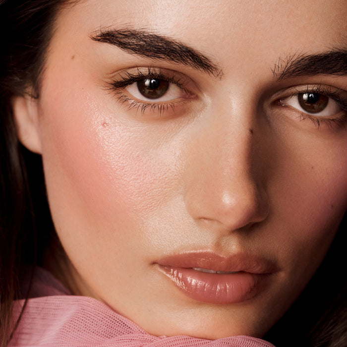 Close-up of a woman's face with a soft focus on her eyes and cheeks.