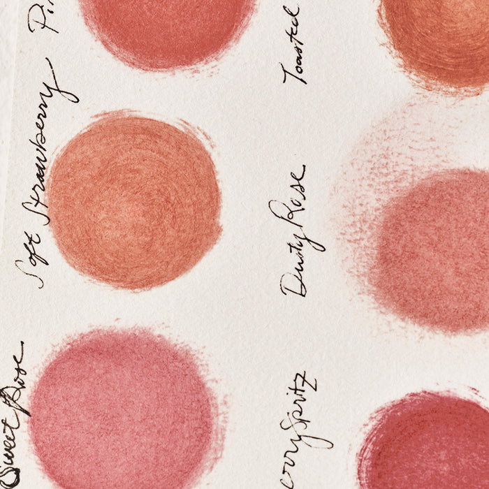 Pattern of pink blush swatches with names on a white background