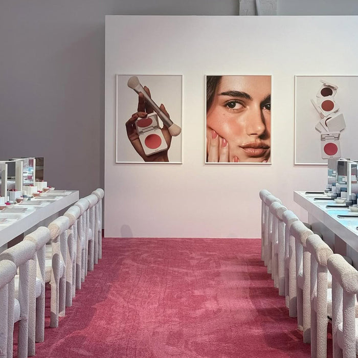 Makeup display with posters on a wall in a school setting