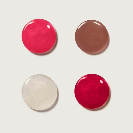 Four swatches of different colored makeup on a white background