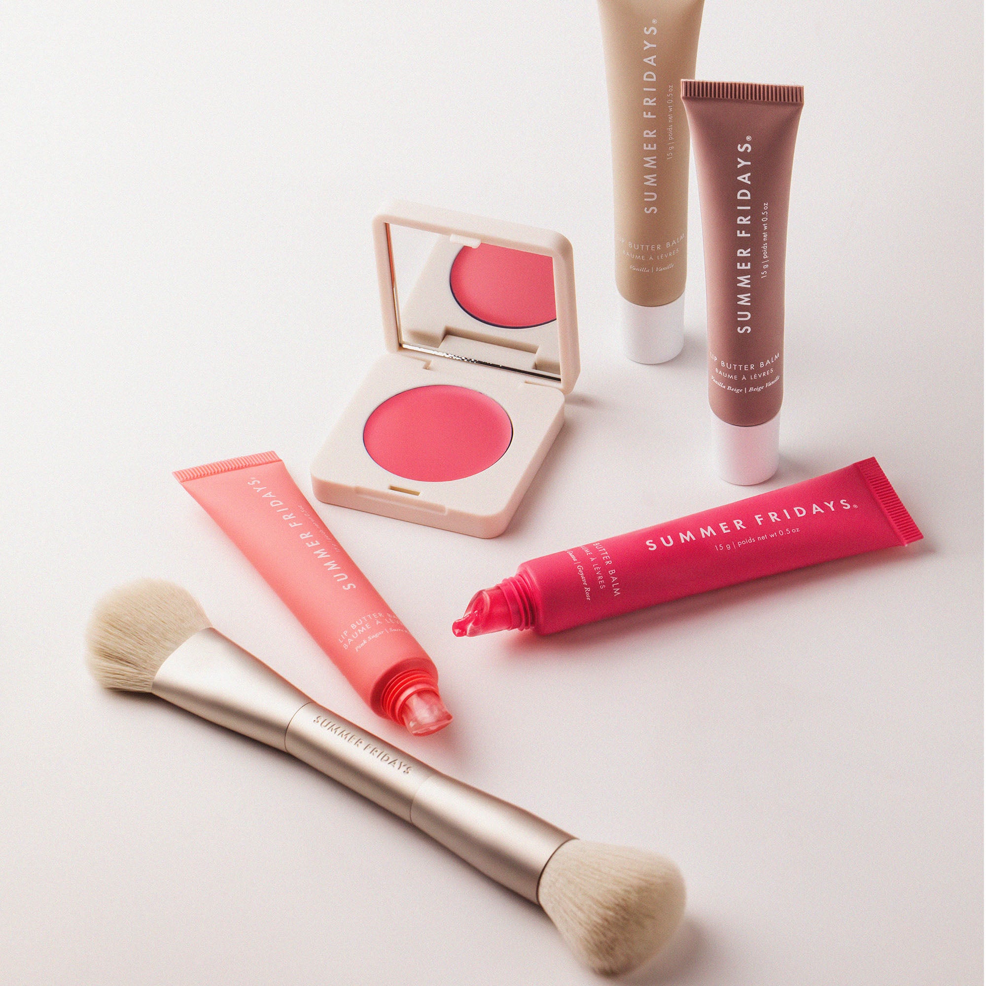 Makeup products including blush, brush, and tubes with 'Summer Fridays' branding on a light background.
