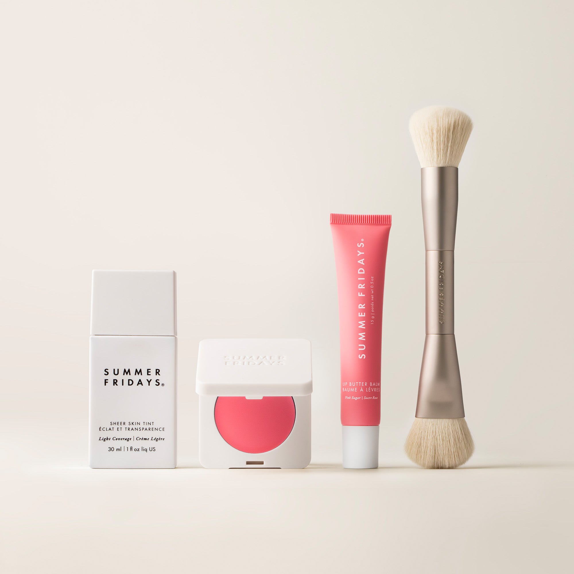 Cosmetic products including a tube, a brush, and packaging with 'Summer Fridays' branding on a light background.