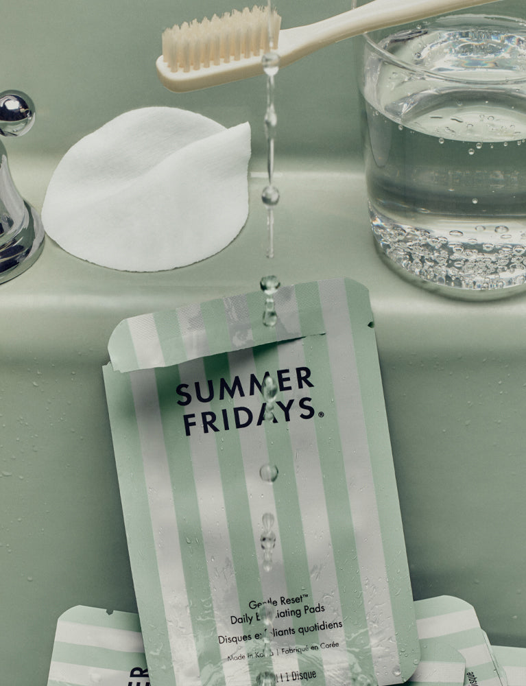 Summer Fridays skincare product with a toothbrush and glass of water on a light green surface
