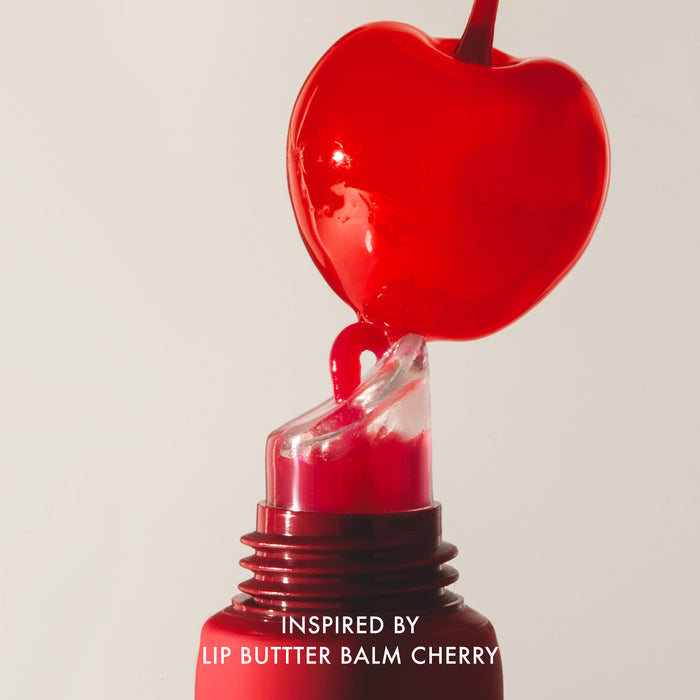 Red lip balm with cherry design on a beige background