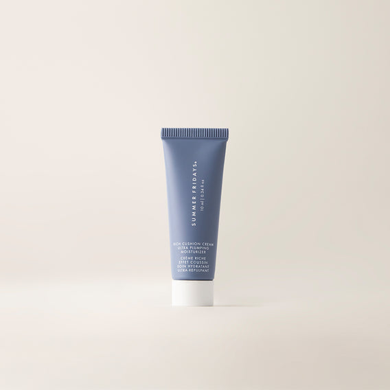 A tube of Rich Cushion Cream Deluxe against a neutral background.