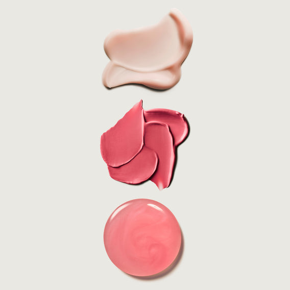 Three swatches of pink makeup on a light beige background