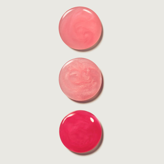 Three lip balm swatches on a light gray background
