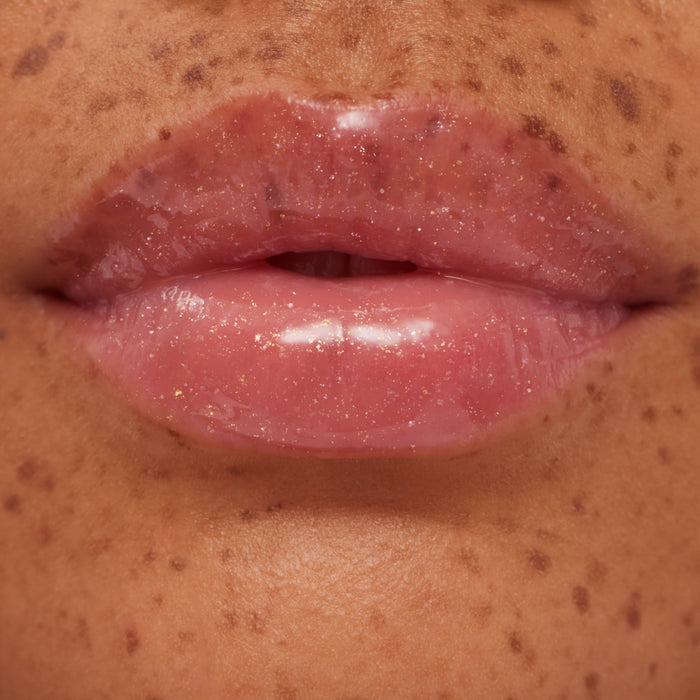 Close-up of a person's lips with a glossy lip product