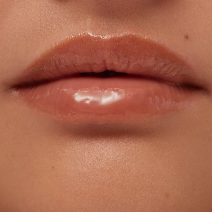 Close-up of a person's lips with a glossy lip product