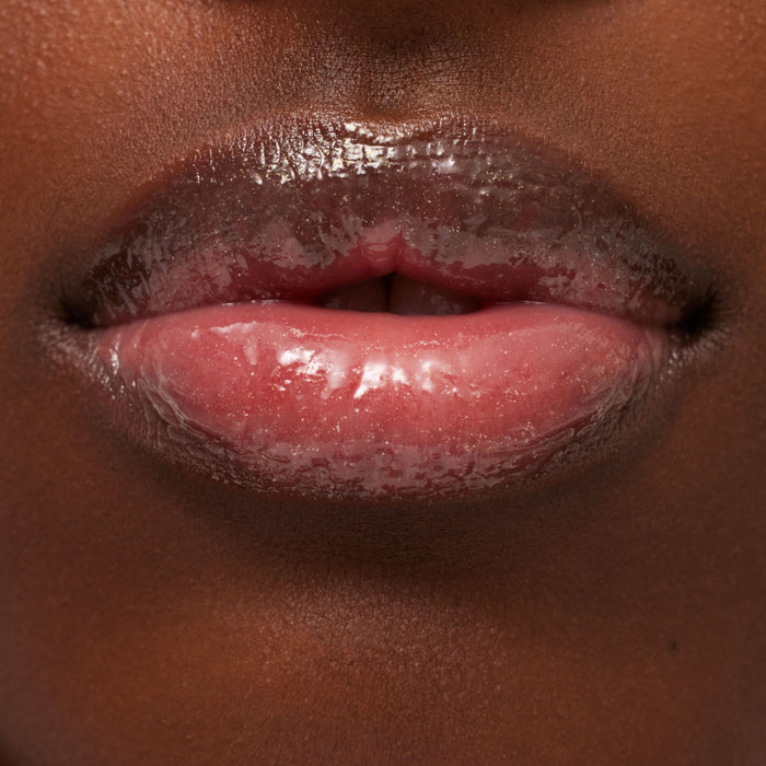 Close-up of glossy pink lips