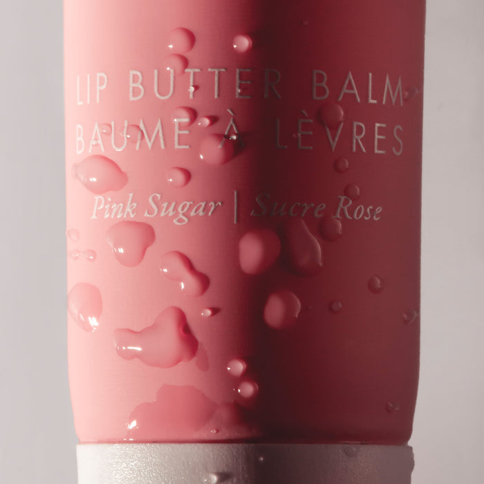 Pink lip butter balm with 'Pink Sugar' flavor on a gray background