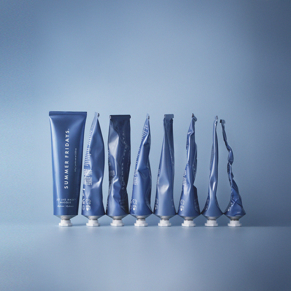 Set of blue cosmetic tubes with 'Summer Fridays' branding on a gradient blue background